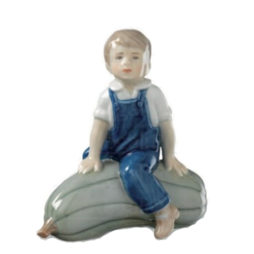 Royal Copenhagen 1021153 Boy with pumpkin Porcellaine figurine and made and painted in enamel
